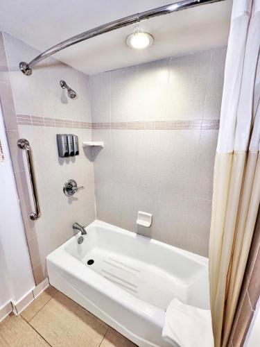 a white bath tub in a bathroom with a shower at Alhambra Hotel in Alhambra