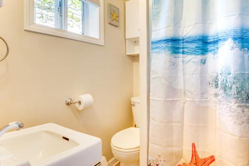 a bathroom with a toilet and a shower curtain at Old Orchard Beach Condo: Steps From the Beach! in Old Orchard Beach
