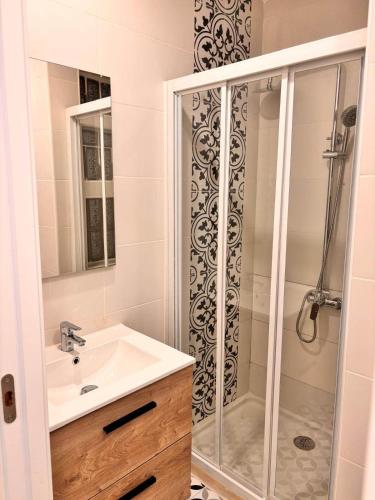 a bathroom with a sink and a shower at Pretty central flat in Ceuta