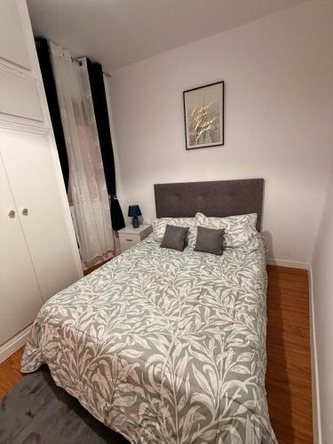 a bedroom with a large bed with two pillows at Pretty central flat in Ceuta