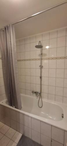 a bathroom with a bath tub with a shower at Apartment in Bergheim