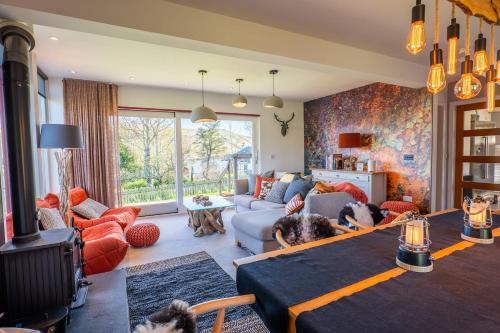 a living room with a dog laying on a table at The Wolfie Lodge in Carbost