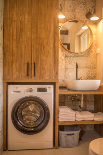 a bathroom with a washing machine and a sink at Kuća za odmor Olea in Stari Grad