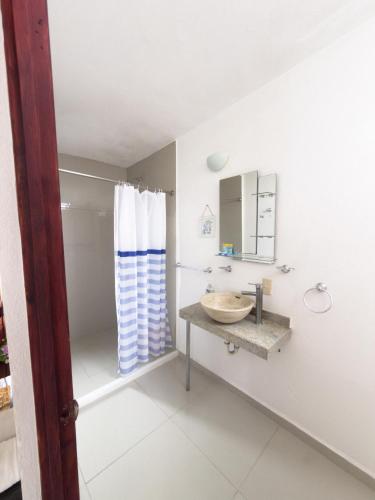 a bathroom with a sink and a shower at Hotel Casa Xicun in Tepoztlán