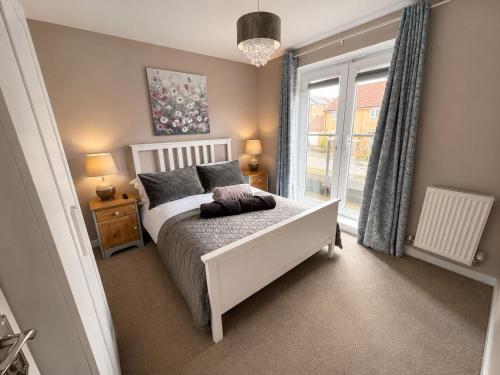 a bedroom with a white bed and a window at MpaNjus - Double Rooms, Shared House in Bristol