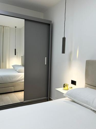 a bedroom with a bed and a large mirror at APP Steps to the Sea 2026 in Funtana