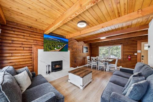 a living room with a couch and a fireplace at Twin Peaks Cabin in South Lake Tahoe