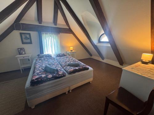 a bedroom with a large bed in a attic at Szaletli in Tihany