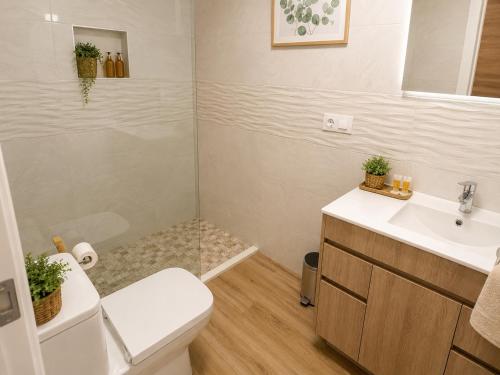 a bathroom with a toilet and a sink at DUNA - Escapada romántica en Punta Paloma in Tarifa