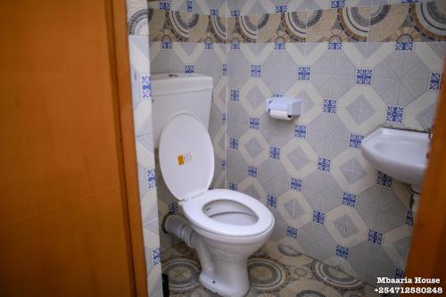 a bathroom with a toilet and a sink at Mbaaria House, Meru in Meru