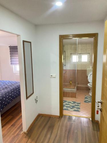 a room with a bathroom with a toilet and a shower at Otoka Hostel in Sarajevo