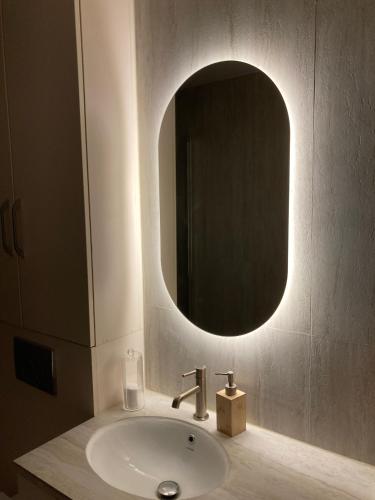 a bathroom with a sink and a mirror at Niva Rest in Pilica