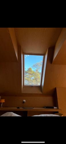 a room with a window in the ceiling of a bedroom at Niva Rest in Pilica