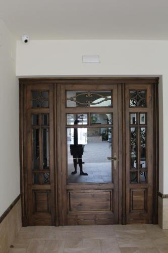 a large wooden door with a person standing behind it at Hostal Garlu in La Rambla