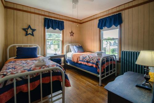 a bedroom with two beds and a window at Old Clark Inn in Marlinton
