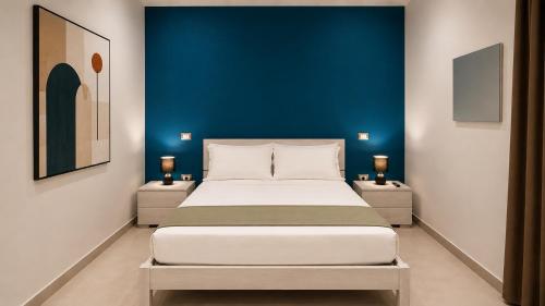 a bedroom with a large bed with a blue wall at The Arco Rooms in Pomigliano dʼArco