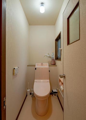 a bathroom with a white toilet in a room at 笑福邸 in Shiogama