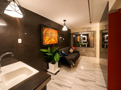 a bathroom with a sink and a couch in a room at Ica Adventures II in Ica