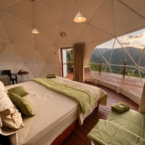a bedroom with a large bed in a tent at Shapaja Glamping in Tarapoto