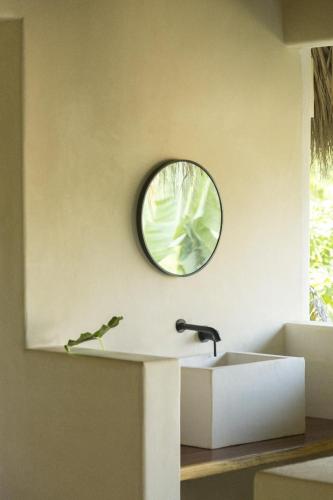 a bathroom with a sink and a mirror on the wall at Angelique's Boutique Spa & Suites in La Unión