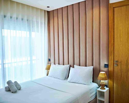 a bedroom with a large bed with a large window at Prestige studio in Maarif