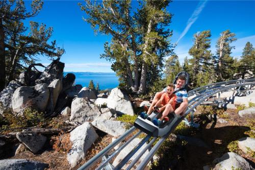 a boy and a child riding on a roller coaster at Tahoe Keys #214 in South Lake Tahoe