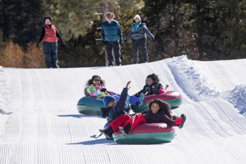 a group of children are riding down a ski slope at Tahoe Keys #214 in South Lake Tahoe