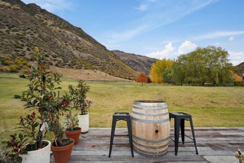 a barrel sitting on top of a table with plants at Gibbston Hideaway in Gibbston