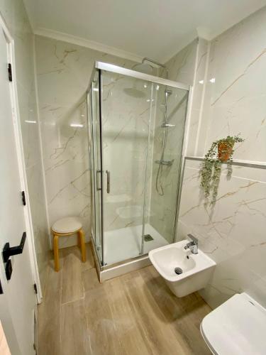 a bathroom with a shower and a sink at Sea View urban apartment in Faro