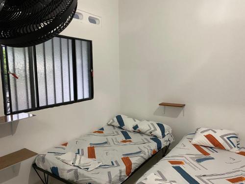a bedroom with a bed and a window at Casa Armonia in Honda