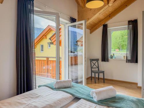 a bedroom with a bed and a large window at Villa Alpenrose in Kötschach