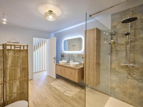 a bathroom with a sink and a glass shower at t Margrietje in Riemst