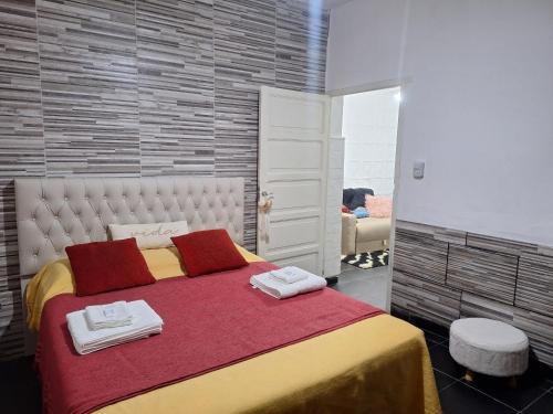 a bedroom with a large bed with towels on it at Noche Hermosa in Chilecito