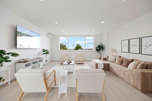a living room with a couch and a table and chairs at 2Homes Villa Renovated Views in La Mesa