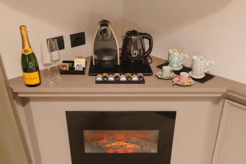 a fireplace in a room with a bottle of wine at Rhea Silvia Luxury Navona in Rome