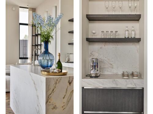 a kitchen with a counter with a blue vase with flowers at Zilte Watervilla in Kamperland