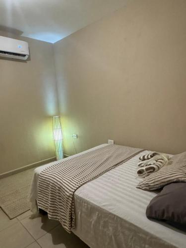 a bedroom with a bed and a light on the wall at Departamento #10 in San Carlos