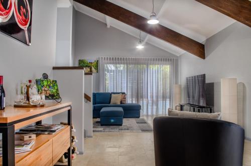 a living room with a couch and a chair at Koblenz Haus - “Heart of the Barossa” - (New Mgmt) in Tanunda