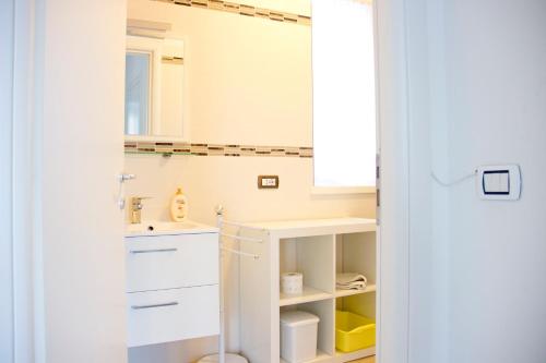 a bathroom with white cabinets and a sink at Lakefront Villa Del Pierangelo in Cremia