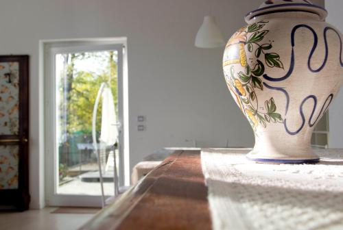 a vase sitting on a table in a room at Lakefront Villa Del Pierangelo in Cremia