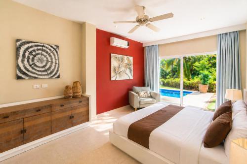 a bedroom with a bed and a sliding glass door at Private Iberosta Villa Lagoon 4BDR- Private Beach and Pool in Punta Cana