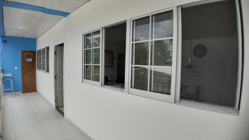 an empty hallway with windows in a building at La Gran Casa in San Andrés