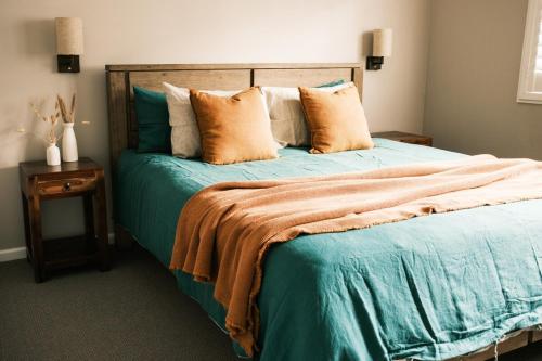 a bedroom with a bed with blue sheets and pillows at VeraLuna in Garden Island Creek