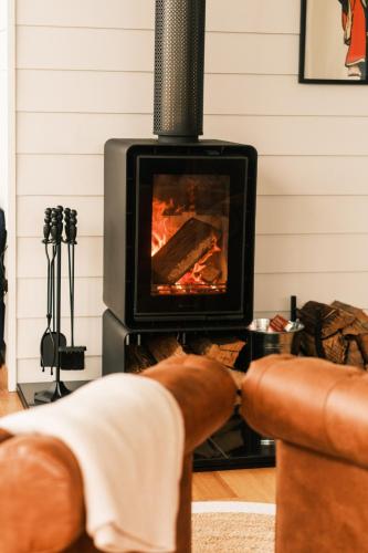 a person sitting in front of a fireplace at VeraLuna in Garden Island Creek