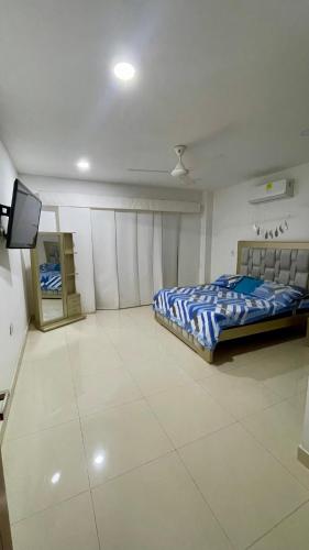 a bedroom with a bed and a tv in it at Casa lujosa lorica in Lorica