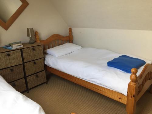 a bedroom with two twin beds and a dresser at Brookvale Cottage in Downpatrick