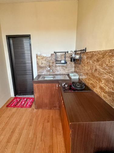 a kitchen with a sink and a counter top at Zambrud Villa Dieng in Kejajar