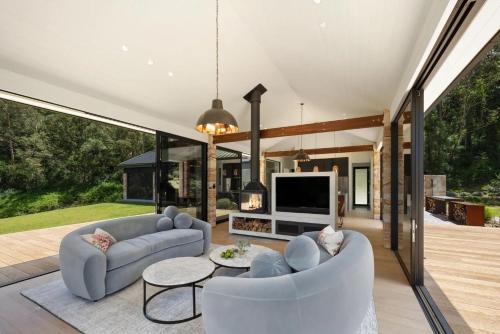 a living room with two couches and a television at Villa Arbosana in Barrengarry