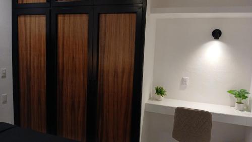 a wooden closet in a room with a table at Orion 2nd Floor in Tepic