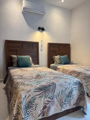 a bedroom with two beds in a room at Orion 2nd Floor in Tepic